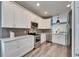 Modern kitchen with white cabinets, quartz countertops and stainless steel appliances at 5610 Golden Isles Dr, Apollo Beach, FL 33572