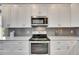 Stainless steel appliances and white shaker cabinets at 5610 Golden Isles Dr, Apollo Beach, FL 33572