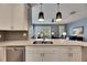Modern kitchen with white cabinets, quartz countertops, and stainless steel appliances at 5610 Golden Isles Dr, Apollo Beach, FL 33572