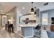 Modern kitchen with white cabinets, quartz countertops, and island at 5610 Golden Isles Dr, Apollo Beach, FL 33572