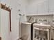 Laundry room with washer, dryer, and additional cabinets at 5610 Golden Isles Dr, Apollo Beach, FL 33572