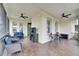 Relaxing screened porch with seating and ceiling fans at 5610 Golden Isles Dr, Apollo Beach, FL 33572