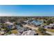 Aerial view of neighborhood with houses, lake, and lush trees at 6008 49Th N Ave, Kenneth City, FL 33709