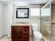 Updated bathroom with granite vanity, glass shower, and tile floors at 6008 49Th N Ave, Kenneth City, FL 33709