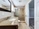 Clean bathroom with granite vanity, glass-enclosed shower, and tile flooring at 6008 49Th N Ave, Kenneth City, FL 33709