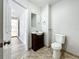 Simple bathroom with dark vanity and view to kitchen at 6008 49Th N Ave, Kenneth City, FL 33709