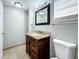 Renovated bathroom with granite countertop, new toilet, and a large mirror at 6008 49Th N Ave, Kenneth City, FL 33709
