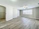 Bright bedroom with wood-look floors, ceiling fan, and exterior access at 6008 49Th N Ave, Kenneth City, FL 33709