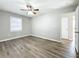 Spacious bedroom with ceiling fan, wood-look floors, and ample closet space at 6008 49Th N Ave, Kenneth City, FL 33709
