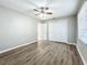 Well-lit bedroom with ceiling fan, neutral walls, and wood-look flooring at 6008 49Th N Ave, Kenneth City, FL 33709