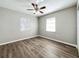 Spacious bedroom with wood-look floors, ceiling fan and two windows at 6008 49Th N Ave, Kenneth City, FL 33709