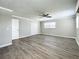 Large bedroom with wood-look floors, double doors, and a ceiling fan at 6008 49Th N Ave, Kenneth City, FL 33709