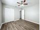 Bedroom with ceiling fan, neutral walls, and wood-look flooring at 6008 49Th N Ave, Kenneth City, FL 33709