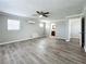 Spacious bedroom with wood-look floors, ceiling fan, and ample closet space at 6008 49Th N Ave, Kenneth City, FL 33709
