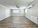 Spacious bedroom with wood-look floors, ceiling fan and double closets at 6008 49Th N Ave, Kenneth City, FL 33709
