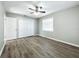 Bright bedroom with ceiling fan, neutral walls, and double door closet at 6008 49Th N Ave, Kenneth City, FL 33709