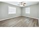Spacious bedroom with ceiling fan, neutral walls, and wood-look flooring at 6008 49Th N Ave, Kenneth City, FL 33709