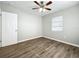 Bright bedroom with wood-look floors, ceiling fan, and window coverings at 6008 49Th N Ave, Kenneth City, FL 33709