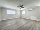 Well-lit bedroom, featuring wood-look floors and a ceiling fan at 6008 49Th N Ave, Kenneth City, FL 33709