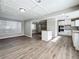 Bright dining area with hardwood floors and adjacent kitchen at 6008 49Th N Ave, Kenneth City, FL 33709