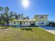 Two-story house with a green exterior, landscaping, and driveway at 6008 49Th N Ave, Kenneth City, FL 33709