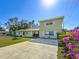 Two-story house with a two-car driveway and bougainvillea at 6008 49Th N Ave, Kenneth City, FL 33709