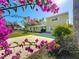 House with a two-car driveway and bougainvillea flowers at 6008 49Th N Ave, Kenneth City, FL 33709