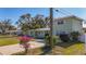 House with a two-car driveway and flowering bushes at 6008 49Th N Ave, Kenneth City, FL 33709