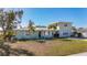 Light green house with a two-car driveway and palm trees at 6008 49Th N Ave, Kenneth City, FL 33709