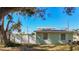 Light green house with white shutters, a fenced yard, and mature tree at 6008 49Th N Ave, Kenneth City, FL 33709