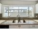 Kitchen features granite countertops, a double sink and a window overlooking the backyard at 6008 49Th N Ave, Kenneth City, FL 33709