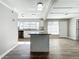 Modern kitchen with island, stainless steel appliances, and light wood flooring at 6008 49Th N Ave, Kenneth City, FL 33709