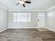 Living room, wood-look floors, and front door with window at 6008 49Th N Ave, Kenneth City, FL 33709