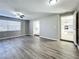 Open living room with wood-look floors and views into kitchen at 6008 49Th N Ave, Kenneth City, FL 33709