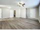 Bright living room featuring wood-look floors and multiple entryways at 6008 49Th N Ave, Kenneth City, FL 33709
