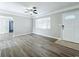 Living room, wood-look floors, and access to kitchen and front door at 6008 49Th N Ave, Kenneth City, FL 33709