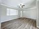 Living room with wood-look floors and access to front door at 6008 49Th N Ave, Kenneth City, FL 33709