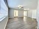 Spacious living room with wood-look floors, ceiling fan and large window at 6008 49Th N Ave, Kenneth City, FL 33709