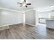 Spacious living room features wood-look floors and kitchen access at 6008 49Th N Ave, Kenneth City, FL 33709