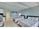 Bedroom with two double beds, kitchenette, and ocean mural at 611 Destiny Dr # 216, Ruskin, FL 33570