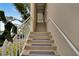 Exterior staircase with white railings leading to condo entrance at 611 Destiny Dr # 216, Ruskin, FL 33570
