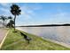 Relaxing waterfront view with bench and lush grass at 611 Destiny Dr # 216, Ruskin, FL 33570