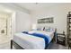 Bright bedroom with a queen-size bed and built-in shelving at 7629 Colonial Ct, Tampa, FL 33615