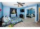 Blue bedroom with full bed, mirrored closet, and TV at 8026 Buttonball Ln, Port Richey, FL 34668