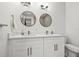 Double vanity bathroom with white cabinets and contemporary mirrors at 8709 Palm Ranches Pl, Tampa, FL 33614