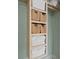 Built-in shelving unit for linens and bathroom storage at 8709 Palm Ranches Pl, Tampa, FL 33614
