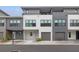 Modern two-story townhome with attached garage and neutral color palette at 8709 Palm Ranches Pl, Tampa, FL 33614