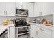 Modern kitchen with stainless steel appliances and white cabinets at 8709 Palm Ranches Pl, Tampa, FL 33614