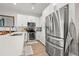 Modern kitchen with white cabinets, stainless steel appliances, and island at 8709 Palm Ranches Pl, Tampa, FL 33614