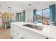 Modern kitchen features a large island with a stainless steel sink at 8709 Palm Ranches Pl, Tampa, FL 33614